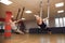 Two young girls do fly yoga and stretches in the studio.