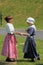 Two young girls dressed in period clothing during reenactment of French and Indian War, Fort Ontario, 2016