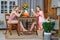 Two young girls have tea in the kitchen decorated in rustic style and talking