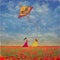 Two young girls with the kite on the field of poppies