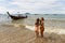 Two young girls pose on the shore of Krabi beach