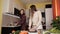 Two young girls prepare a festive dinner with chicken spices