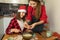 Two young girls are preparing Christmas cookies at home in the kitchen. T