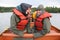 Two young girls in rain gear on canoe near Glacier Point, Aklaska.