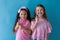 Two young girls show toothbrushes dentistry nice