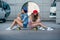 Two young girls sitting on longboard