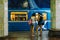 Two young girls standing on underground station on background of riding train