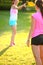 Two young girls are throwing a frisbee