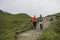 Two young girls walking together and talking about something on the trail of Hehuan Mountain.