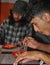 Two young guys eating noodles in the cafe. Two male friends having fast food