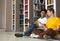 Two young guys having fun while studying at library