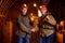 Two young guys in working uniform and protective helmets, shaking hands