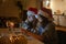 Two young happy beautiful women girlfriends lesbian couple with glasses of champagne in red santa hats celebrate new