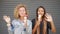 Two Young Happy Carefree Mixed Race Girls Waving Hands on Camera and Eating Ice Cream Cones. Hipster Lifestyle HD