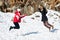 Two young happy teenage girls jumping with pleasure at snow