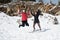 Two young happy teenage girls jumping with pleasure at snow