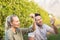 Two young happy vintners holding a glass of wine and grapes