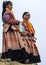 Two young Hmong women show and wait at Sunday market.