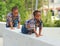 Two Young Kids Crawling On Ledge
