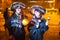 Two young ladies dressed in festive costumes singing