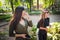 Two young latin female friends walking at the woods. Embrace each other and laughing. Friends making selfie. Two beautiful latin