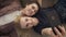 Two young lesbian girls lie on the couch, do selfie on a smartphone, lovers, lgbt, young couple. top shot 60 fps
