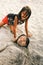Two young little girl on the beach covered with the sand
