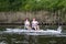 Two young male athletes concentrating on rowing in a regatta race.  Boat says Bradford Grammar School