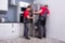 Two Young Male Movers Placing Steel Refrigerator In Kitchen