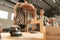 Two young men carpenters making furniture in warehouse of wood factory