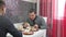 Two Young Men Eating Breakfast In Kitchen Together - cooking, food and home concept lunch two friends men indoors