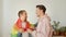 Two young men stand together, covered with a lgbt flag, and dance a little