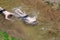 Two young men swim underwater in a shallow small river early spring