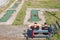 Two young men wearing Novi beograd tshirts in front of Abandoned mini golf course with decaying and rusting golf holes.