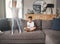 Two young mixed race siblings showing their different personalities while sitting on a sofa at home. Cute child looking