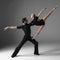 Two young modern ballet dancers on gray studio