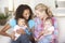 Two Young Mothers On Sofa At Home