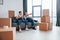 Two young movers in blue uniform working indoors in the room