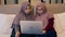 Two young muslim woman watch video on laptop in the bedroom