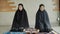 Two young Muslim women are performing prayers. Islamic religion,part 2