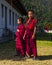 Two young novices monks stand on the lawn . Trashiyangtse Dzong , eastern Bhutan