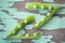 Two young open fresh juicy green pea pods on an old vintage background