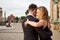 Two young people dancing tango outside on city square