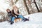 Two young people sliding on a sled