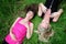 Two young pretty women laying in grass