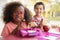 Two young school kids eating their packed lunches together