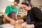 Two young shoemakers preparing shoe lasts in a workshop