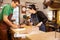 Two young shoemakers preparing shoe lasts in a workshop