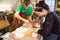 Two young shoemakers preparing shoe lasts in a workshop