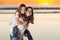 Two Young Sisters Piggyback Portrait on The Beach